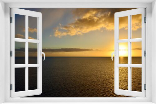 Fototapeta Naklejka Na Ścianę Okno 3D - Golden sunset at sea, sailing boat on horizon, reflections of sunrays, sunset sky with clouds