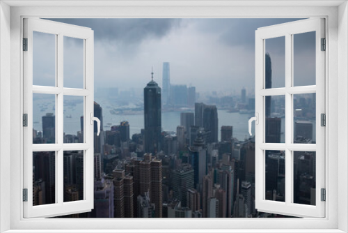 Fototapeta Naklejka Na Ścianę Okno 3D - Skyscrapers, sea shore with ships, dark clouds in business area in mist in Hong Kong, China, view from Queen Garden