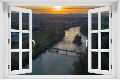 Fototapeta Naklejka Na Ścianę Okno 3D - sunset over the river with city in background