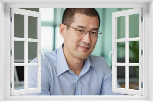 An asian young businessman in glasses and shirt