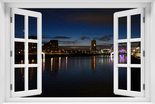 Fototapeta Naklejka Na Ścianę Okno 3D - Glasgow Scotland: 11th Feb 2024: The Clyde Arc illuminated at night on the Banks of the River Clyde aka the Squinty Bridge