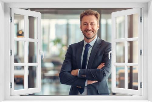 Caucasian business man portrait. Handsome, happy man wearing suit standing in modern office. Smiling white male manager looking at camera in workplace area.