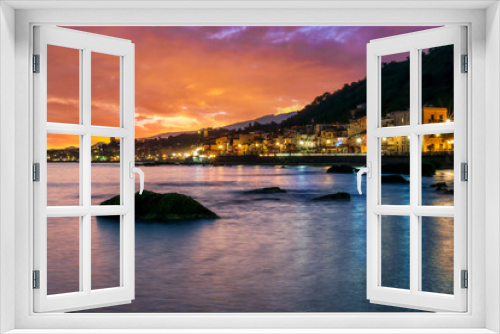 Fototapeta Naklejka Na Ścianę Okno 3D - evening or night landscape of evening town coastline in golden lights and sea gulf with calm water and nice reflections with beautisul sunset sky on background