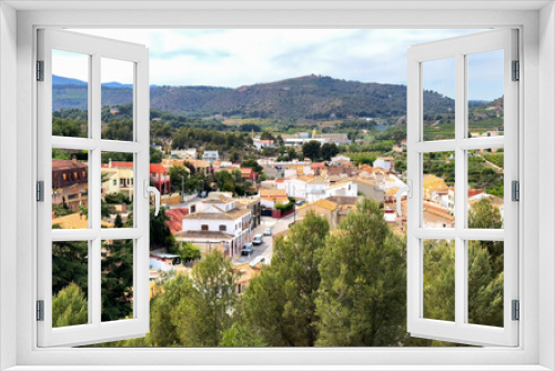 Torres Torres town village, Valencia, Spain. Rural landscape. Buildings and houses in city. Town at mountain. Town at Mountains hills. Houses roofs in countryside. Olive farm field, Orange field