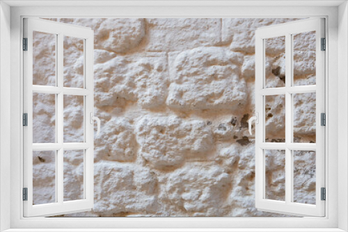 Fototapeta Naklejka Na Ścianę Okno 3D - Close up of whitewashed stone wall in one of the ancient and monumental city of Rhodes in Greece