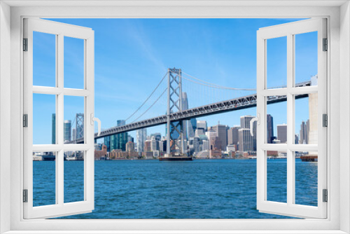 Fototapeta Naklejka Na Ścianę Okno 3D - The Oakland Bay Bridge and the downtown San Francisco skyline as viewed from the San Francisco Bay.