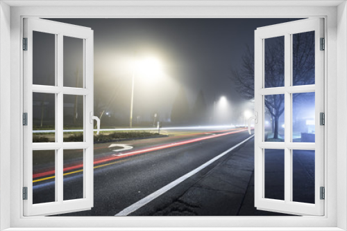 Fototapeta Naklejka Na Ścianę Okno 3D - Road at night with fog and long exposure of car trail