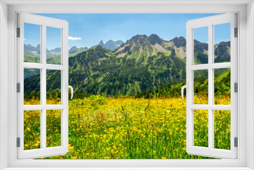 Fototapeta Naklejka Na Ścianę Okno 3D - Berge mit gelber Blumenwiese im Vordergrund