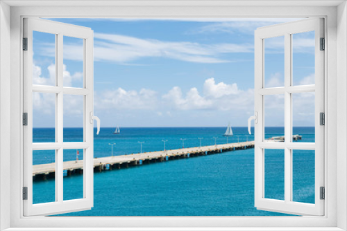 Fototapeta Naklejka Na Ścianę Okno 3D - Two White Sailboats Beyond Long Concrete Pier