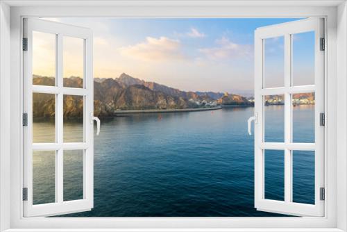 Fototapeta Naklejka Na Ścianę Okno 3D - Early morning view from the sea of the old city, Mutrah Fort and Mutrah Corniche waterfront at the Port Sultan Qaboos of Muscat Oman along the Gulf of Oman in the Arabian Sea	