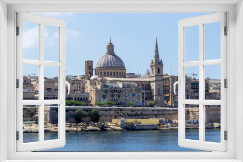 Fototapeta Naklejka Na Ścianę Okno 3D - Valletta, Malta - June 9th 2016: The fortified capital city Valletta with the dome of Basilica of Our Lady of Mount Carmel and the tower of Saint Paul's Pro-Cathedral overlooking  Marsamxett Harbour.