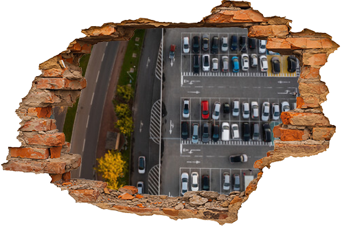 Aerial view of large car parking with many parked cars. Car park near shopping mall with lines and markings for vehicle places and directions