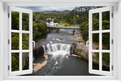 Fototapeta Naklejka Na Ścianę Okno 3D - Aerial shot of Haruru Falls surrounded by greenery in Northland, New Zealand