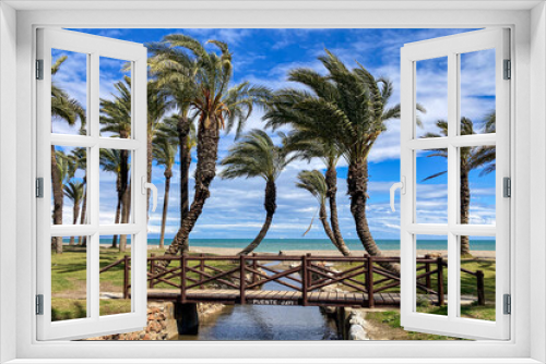 Fototapeta Naklejka Na Ścianę Okno 3D - Wooden small bridge on palms and sea background in Torremolinos, Spain