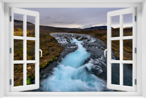 Fototapeta Naklejka Na Ścianę Okno 3D - Landscape of Bruarfoss waterfall in Iceland at sunset. Bruarfoss famous natural landmark and tourist destination place. Travel and natural Concept of the Mystery of the blue Waterfall.