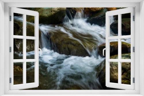 Fototapeta Naklejka Na Ścianę Okno 3D - Long exposure image of stream water with rocks