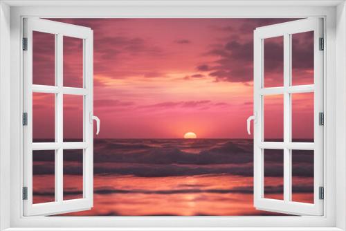 Fototapeta Naklejka Na Ścianę Okno 3D - A pink sunset over the ocean, with waves gently lapping at shore and a distant sun setting behind dark clouds. The sky is painted in shades of orange and purple as it sets on horizon. 