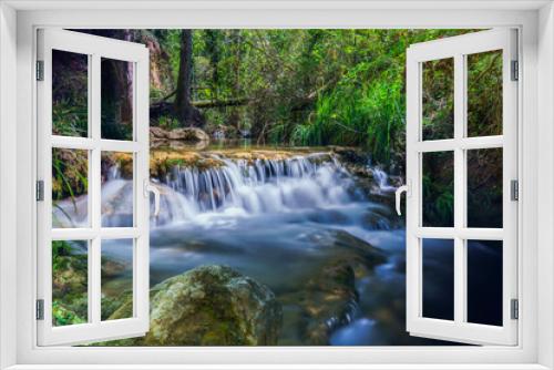 Fototapeta Naklejka Na Ścianę Okno 3D - long exposure silk effect photograph of a waterfall in a mountain stream with lush vegetation