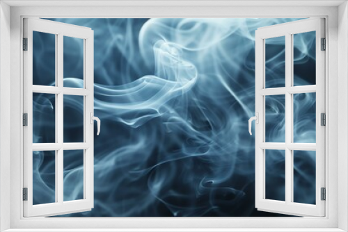 Wispy blue smoke curls and swirls against a black background.