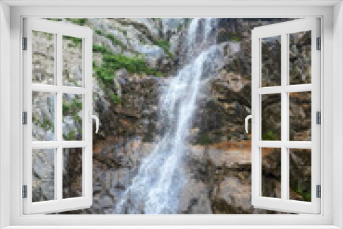Fototapeta Naklejka Na Ścianę Okno 3D - A large beautiful waterfall flowing down from the cliff. Natural landscape