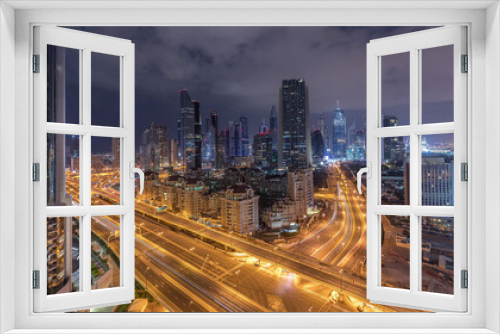 Fototapeta Naklejka Na Ścianę Okno 3D - Skyline view of the buildings of Sheikh Zayed Road and DIFC night to day timelapse in Dubai, UAE.