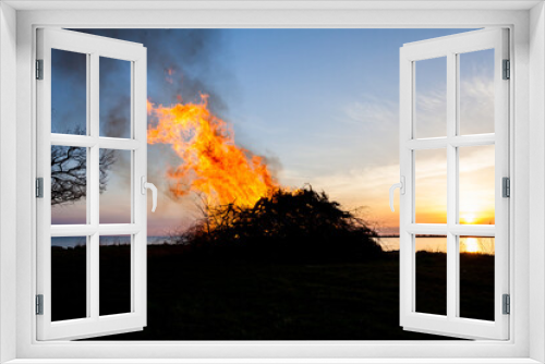 Fototapeta Naklejka Na Ścianę Okno 3D - walpurgis eve celebration Sweden flames agianst sunset ocean horizon