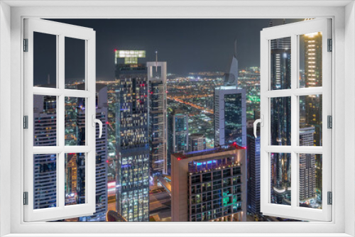 Fototapeta Naklejka Na Ścianę Okno 3D - Skyline of the buildings of Sheikh Zayed Road and DIFC aerial night timelapse in Dubai, UAE.