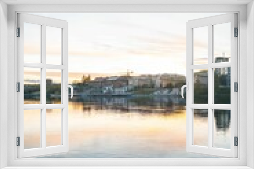 Fototapeta Naklejka Na Ścianę Okno 3D - Vertical shot of a peaceful river at sunset with town architecture, Skelleftea, Sweden