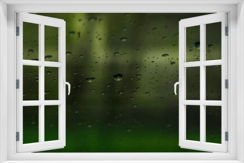 Fototapeta Naklejka Na Ścianę Okno 3D - water drops on glass on a green background