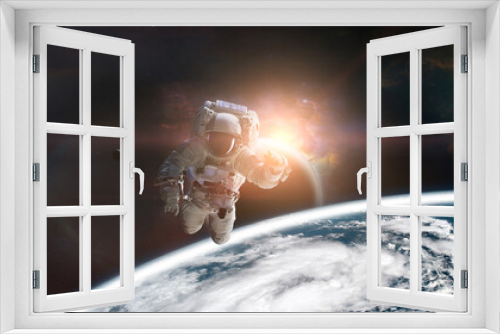 Fototapeta Naklejka Na Ścianę Okno 3D - Astronaut in outer space on low-orbit of Earth planet with sunlight. Elements of this image furnished by NASA.