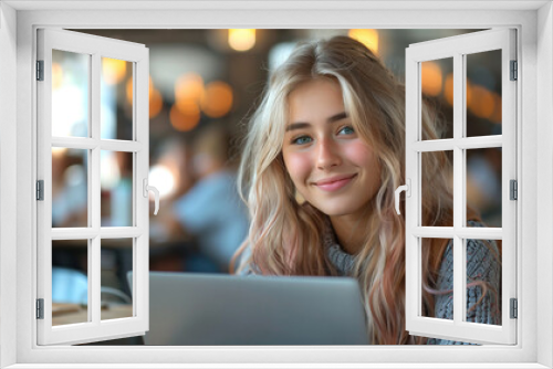 Happy high school girl using laptop in classroom.