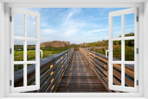 Fototapeta Naklejka Na Ścianę Okno 3D - Boardwalk and sunrise cloudscape over constructed wetlands of Green Cay Nature Center in Boynton Beach, Florida..