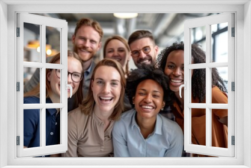 Portrait of happy multiethnic business people looking at camera in office