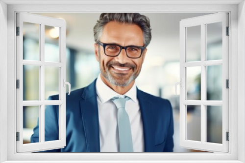 portrait of smiling and friendly looking middle aged attractive businessman