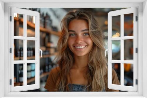 A young woman with a friendly smile poses in a warmly lit cozy barbershop setting