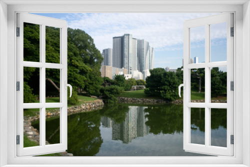Fototapeta Naklejka Na Ścianę Okno 3D - The Gardens of Hamarikyu are a public park in Chūō, Tokyo, Japan. Located at the mouth of the Sumida River they are surrounded by modern buildings.
