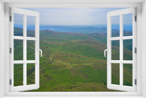 Early spring green mountains from above, panoramic view of hills and nature. Aerial photo taken from a drone.