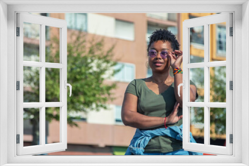 african american woman with arms crossed on the street