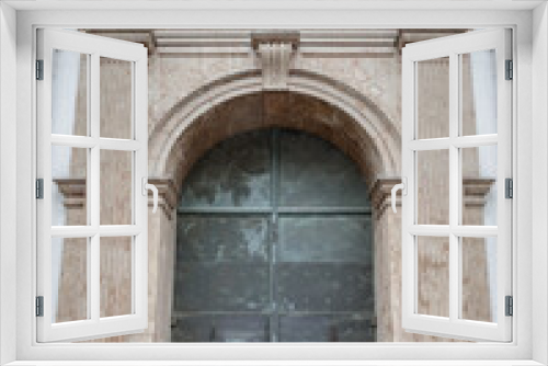 Entrance iron doorway and Decorated arch wall of St. Michael's Church (Michaelskirche Jesuit church) in Munich pedestrian zone. It is the largest Renaissance church north of the Alps. Space for text, 