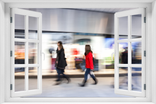 Shopper walking past a store window, zoom effect, motion blur