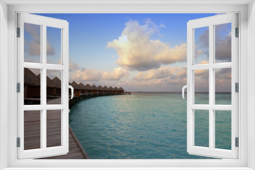 Fototapeta Naklejka Na Ścianę Okno 3D - Houses over the sea at sunrise. Maldives