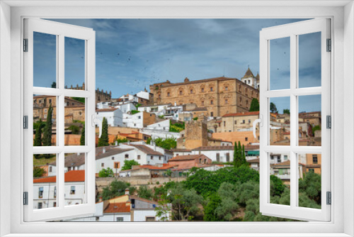 Vista panorámica  del casco histórico de la ciudad española de Cáceres con vistas a los tejados de tejas marrones de edificios antiguos alrededor de la plaza principal en el soleado día de primavera, 