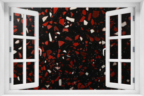  red and white shards scattered on a black background, resembling broken glass or ceramic pieces.
