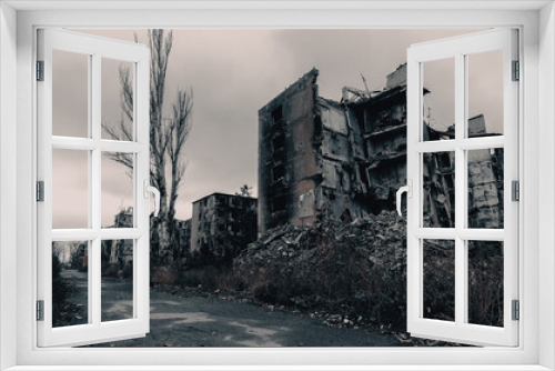 Fototapeta Naklejka Na Ścianę Okno 3D - destroyed and burned houses in the city Russia Ukraine war