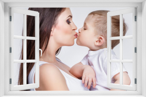 happy mother with a child on light grey background