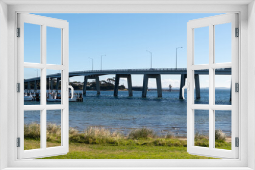 Fototapeta Naklejka Na Ścianę Okno 3D - Panoramic coastal scenery of Phillip Island bridge and ships berth by the shore. at San Remo, VIC Australia.It is a cantilever bridge in Victoria that connects the Australian mainland.