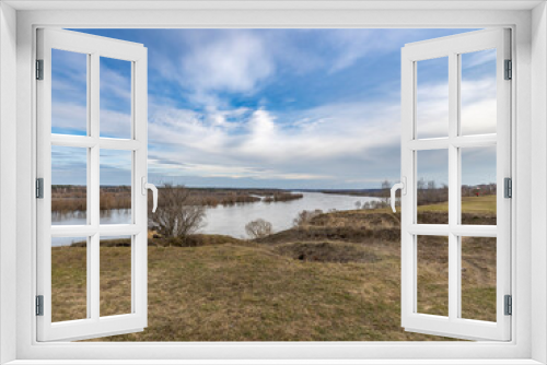 Fototapeta Naklejka Na Ścianę Okno 3D - early spring flood, high water in the countryside, river overflowing its banks, trees in the water, flooded banks, environmental pollution, ecology