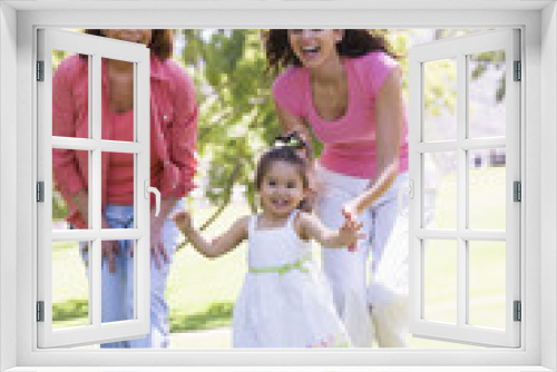 Grandmother with adult daughter and granddaughter in park