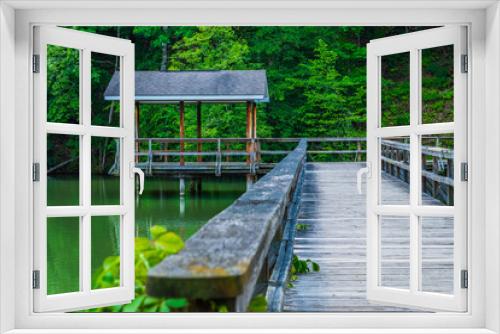 Fototapeta Naklejka Na Ścianę Okno 3D - Wooden walkway with cupola on forested lake in Tennessee.