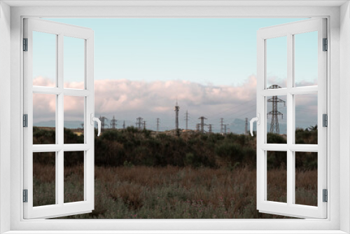 Fototapeta Naklejka Na Ścianę Okno 3D - Electricity Pylons in Serene Landscape